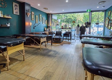 Modern interior of The Hanged Man Tattoo & Barber in Manly, New South Wales, AU with tattoo stations and décor.