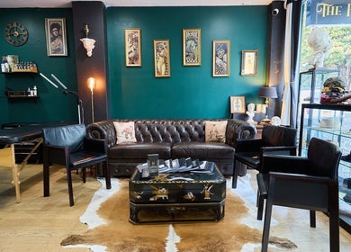 Stylish interior of The Hanged Man Tattoo & Barber in Manly, New South Wales, AU, showcasing a vintage-themed lounge.