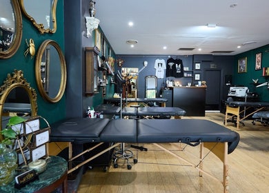 Interior of The Hanged Man Tattoo & Barber, Manly, New South Wales, AU with stylish decor and tattooing chairs.