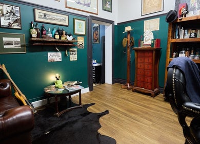 Cozy vintage lounge at The Hanged Man Tattoo & Barber, Manly, New South Wales, AU. Classic decor and leather seating.