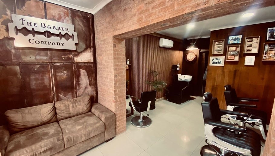 Cozy interior of Barber James in East London, Eastern Cape, ZA with vintage decor and comfortable seating.