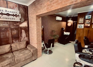 Cozy interior of Barber James in East London, Eastern Cape, ZA with vintage decor and comfortable seating.