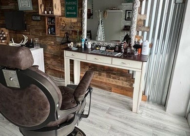Barber James, East London, Eastern Cape: Rustic barber chair with classic decor and grooming tools.