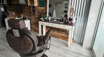 Barber James, East London, Eastern Cape: Rustic barber chair with classic decor and grooming tools.
