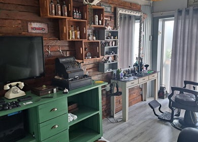 Interior of Barber James in East London, Eastern Cape, ZA, showcasing rustic barber chair and vintage decor.