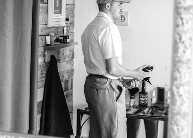 Barber James stylist preparing tools in East London, Eastern Cape, ZA, showcasing classic barber shop ambiance.