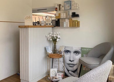 Elegant reception area at The Ultimate Touch Beauty, Wymondham, England. Cozy seating with beauty product displays.