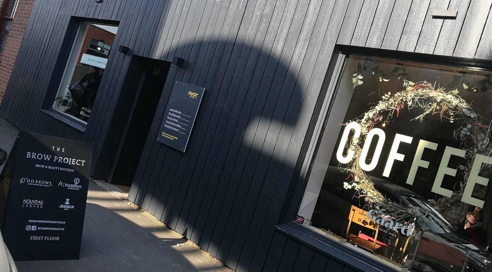 Exterior of The Brow Project in Sheffield, England, GB showcasing its sleek design and welcoming sign.