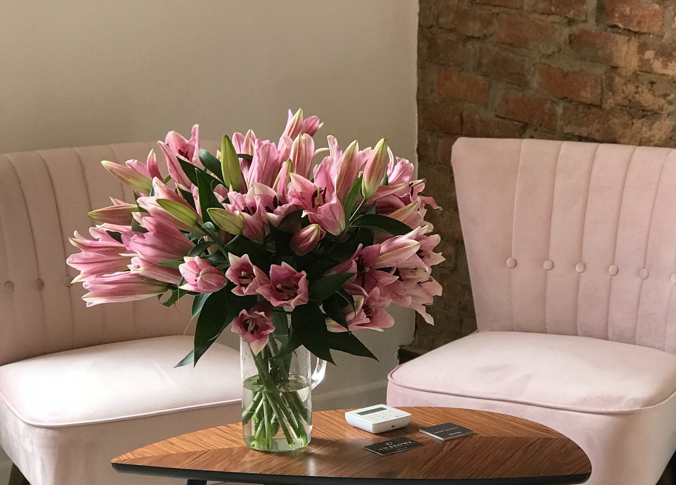 Cozy pink chairs and flowers at The Brow Project, Sheffield, England, GB, offering a tranquil wellness ambiance.