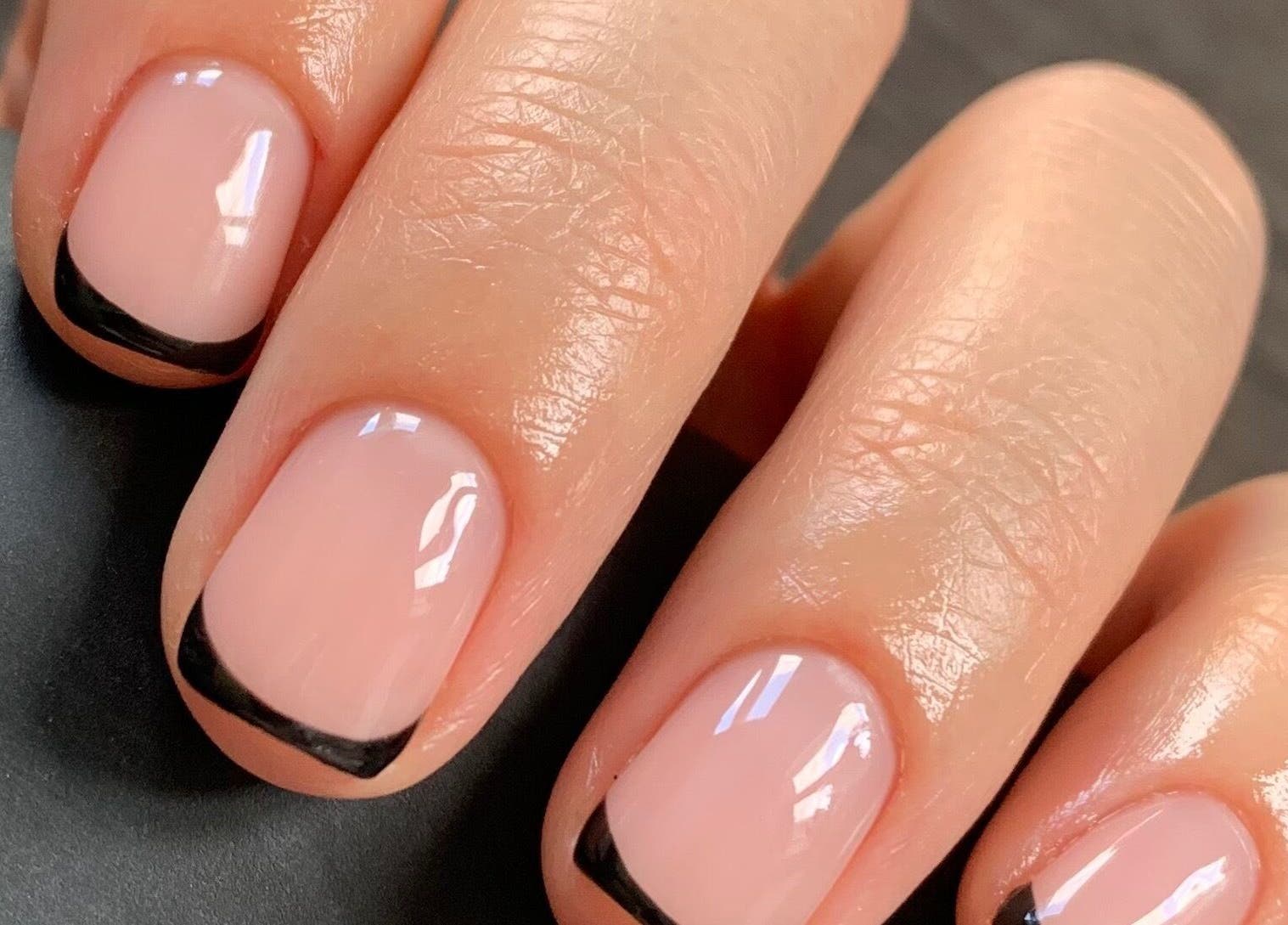 Elegant French manicure by Beauty by Roxanne, Fleetwood, England, GB. Close-up of nails with black tips.