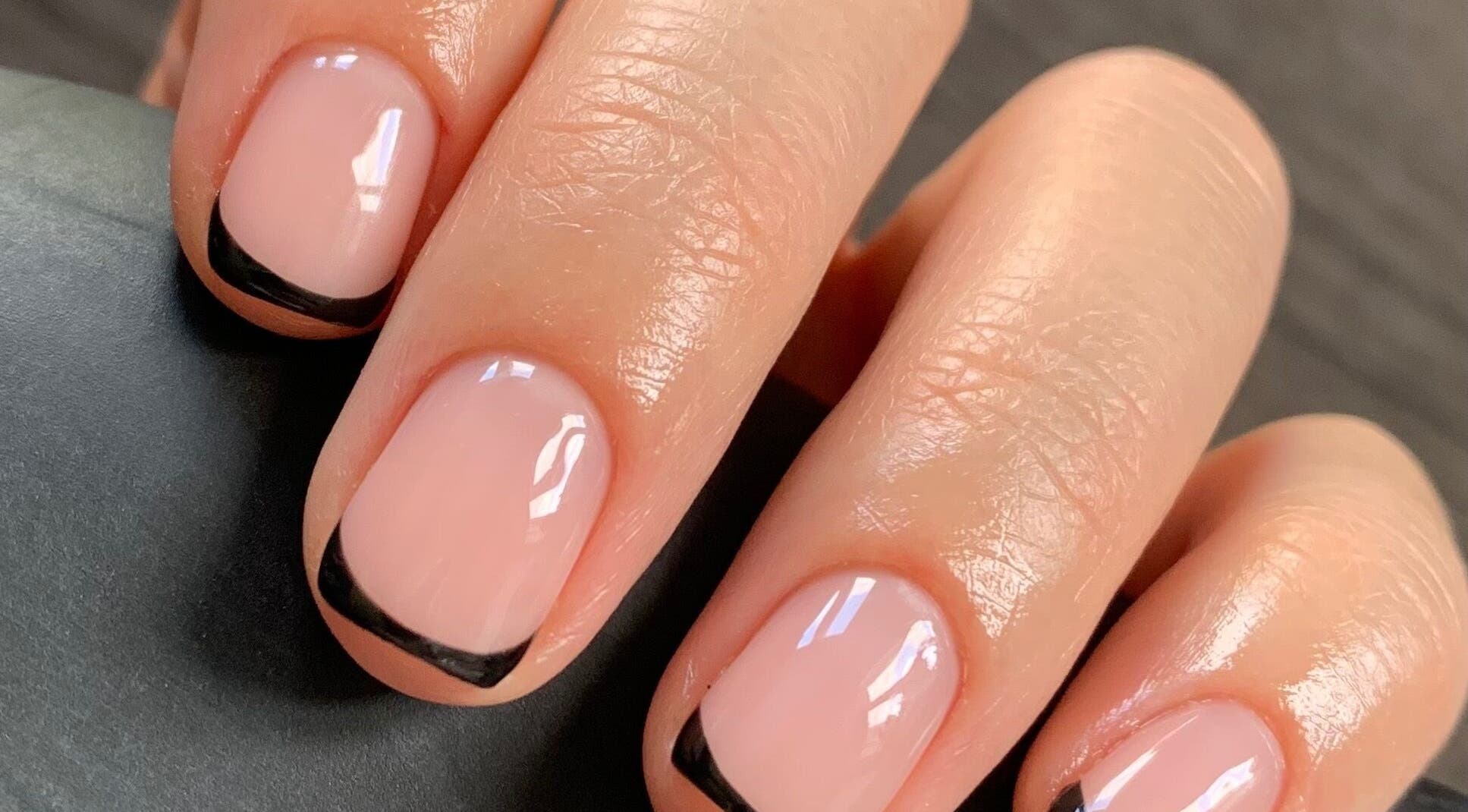 Elegant French manicure by Beauty by Roxanne, Fleetwood, England, GB. Close-up of nails with black tips.