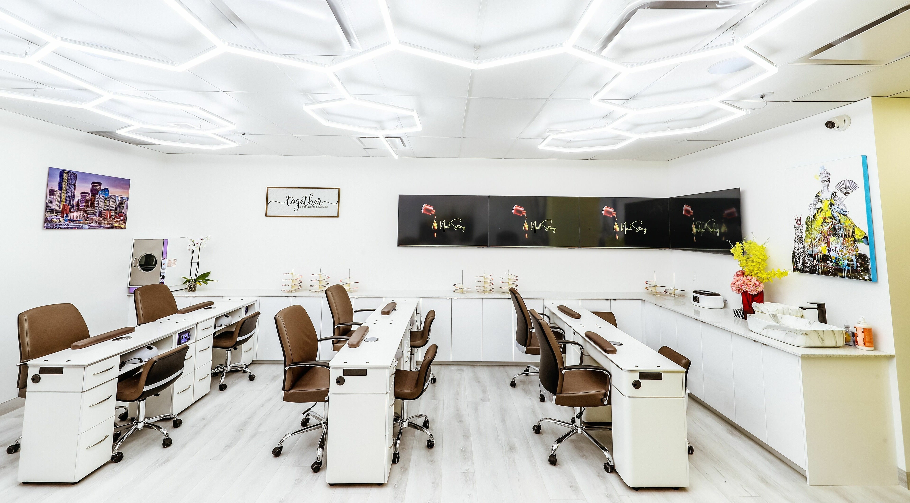 Modern nail studio interior at A Nail Story, Calgary, Alberta, CA, with stylish workstations and elegant decor.