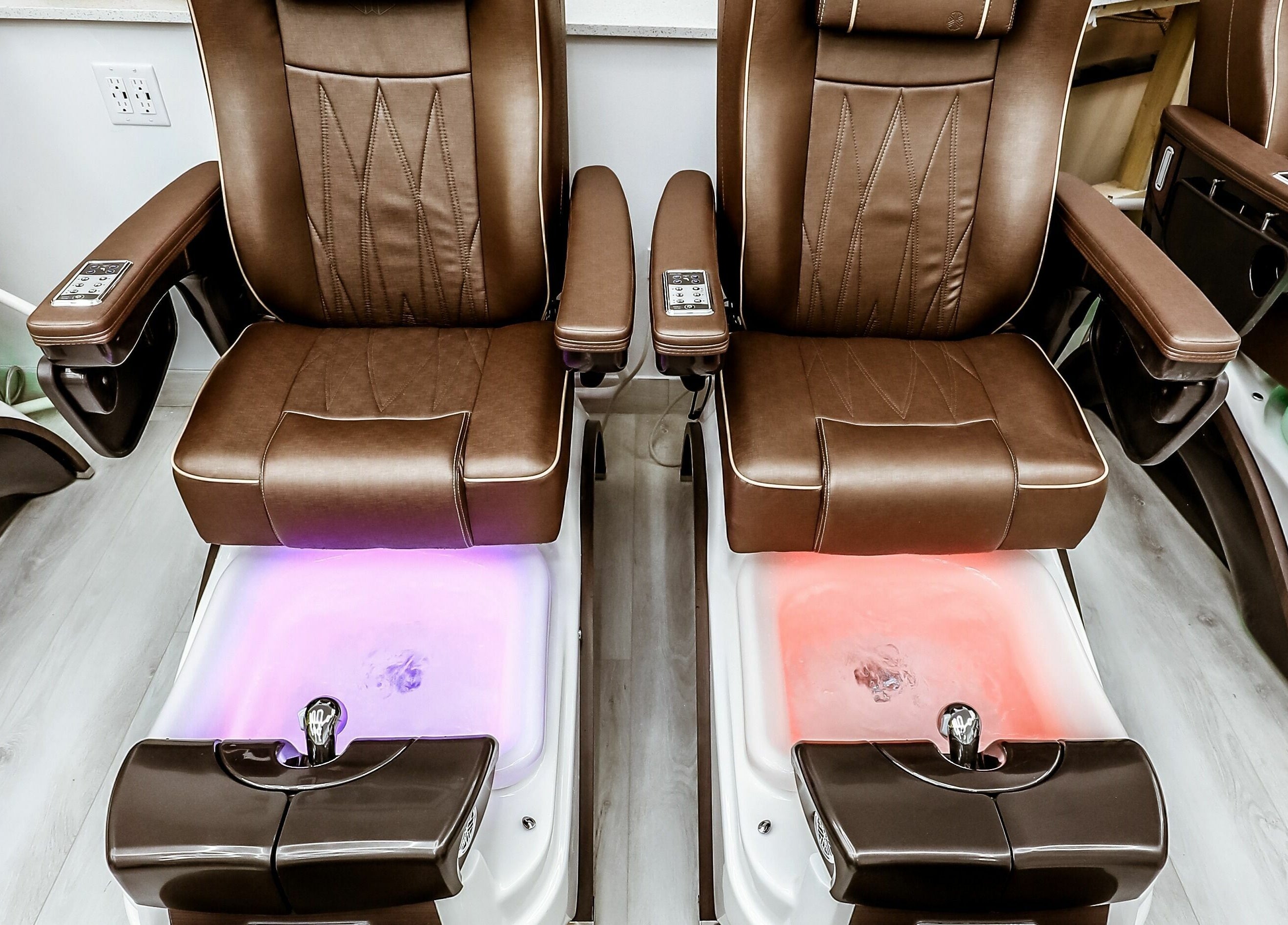 Elegant pedicure chairs at A Nail Story, Calgary, Alberta, CA, offering ultimate relaxation.