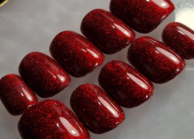Elegant red glitter nails at Trulyou, Swindon, England, GB. Perfect for standout style.