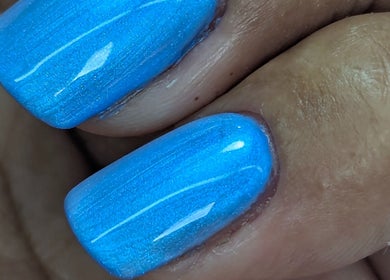 Vibrant blue manicure at Trulyou, Swindon, England, GB, showcasing polished nails with a glossy finish.