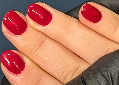 Elegant scarlet nails polished at Trulyou in Swindon, England, GB. A perfect example of luxury manicure art.