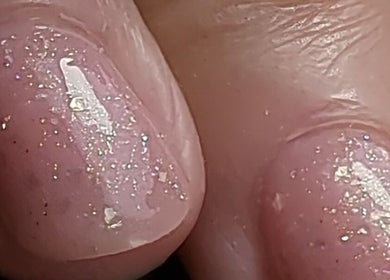 Close-up of glossy glitter nails at Trulyou, Swindon, England, GB, showcasing sparkling beauty.
