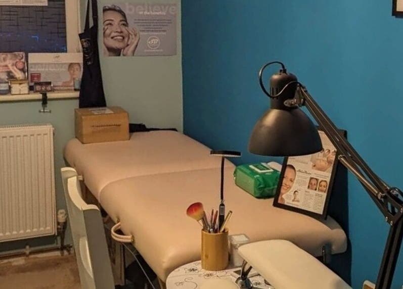 Treatment room at Trulyou, Swindon, England, GB with massage table and skincare products.