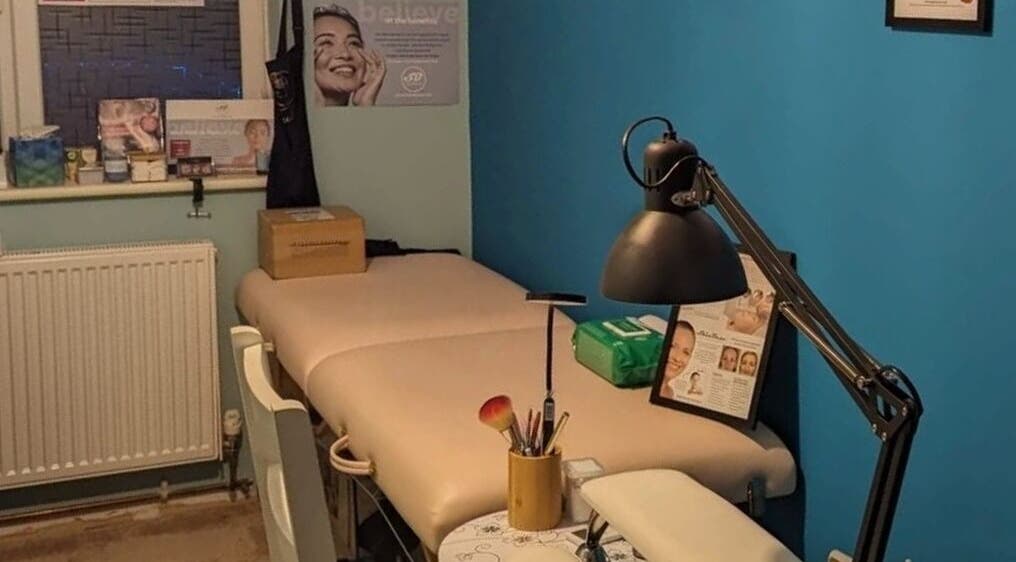 Treatment room at Trulyou, Swindon, England, GB with massage table and skincare products.