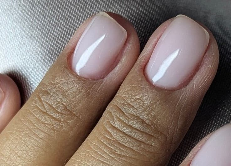 Close-up of manicured nails at Trulyou, Swindon, England, GB, showcasing elegant pink polish.