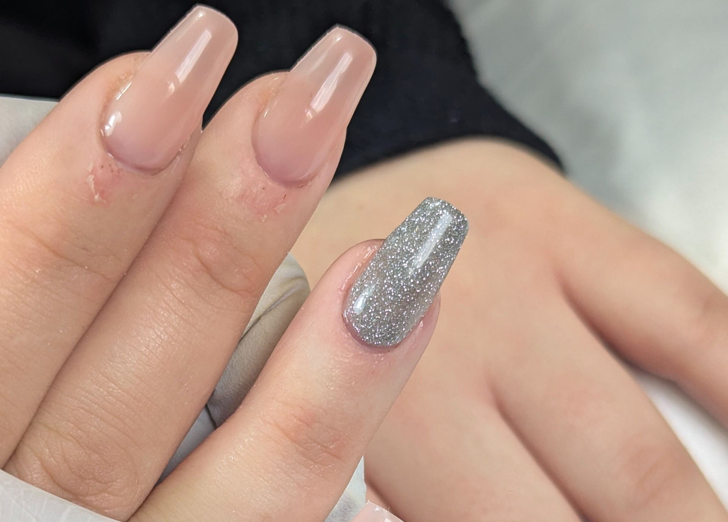 Glamorous nail art at Trulyou, Swindon, England. Elegant nude and silver glitter nails.