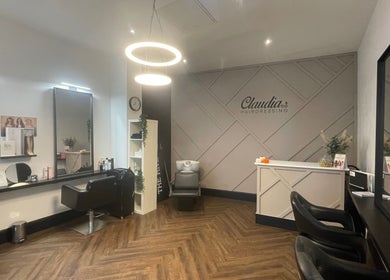 Elegant interior of Claudia & Co Hairdressing in Warrington, England, showcasing stylish salon chairs and decor.