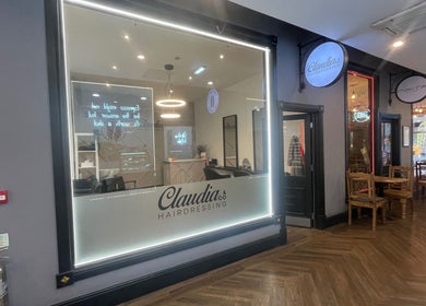 Front view of Claudia & Co Hairdressing in Warrington, England, GB, showcasing a modern and inviting salon design.
