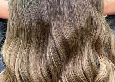 Beautifully styled wavy hair at Claudia & Co Hairdressing, Warrington, England, GB showcasing elegant brown tones.