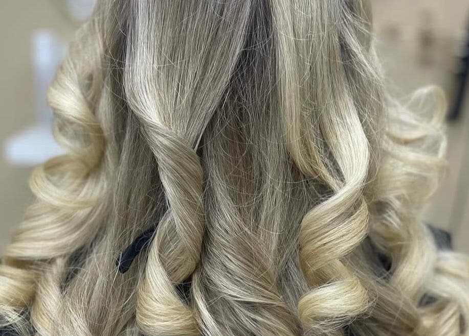 Elegant blonde curls styled at The Hair Casa in Warrington, England, GB, showcasing expert hair craftsmanship.