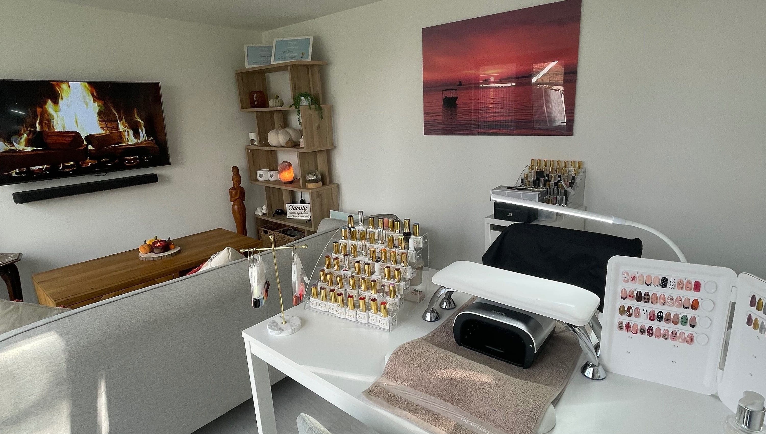 Nail station setup at Maddie's Beauty Room, Great Baddow, England, GB with cozy decor and polish display.