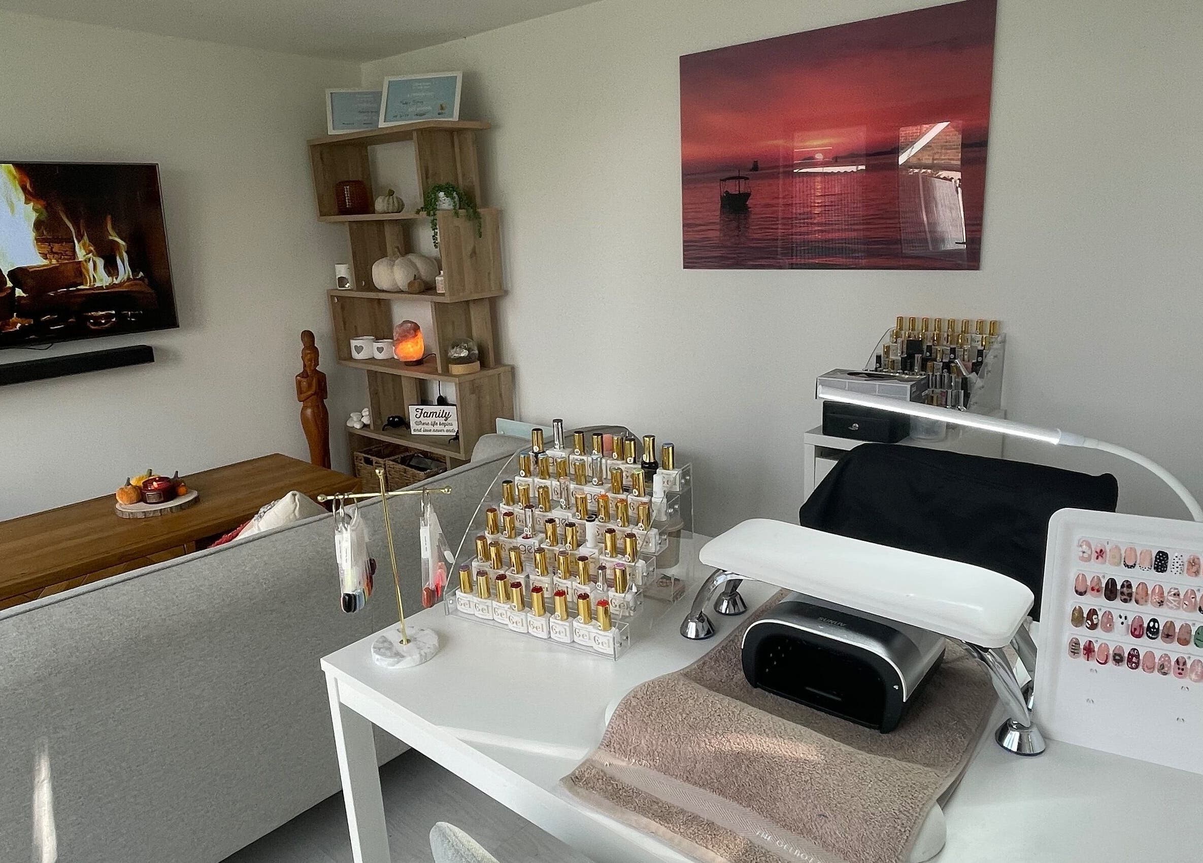 Nail station setup at Maddie's Beauty Room, Great Baddow, England, GB with cozy decor and polish display.