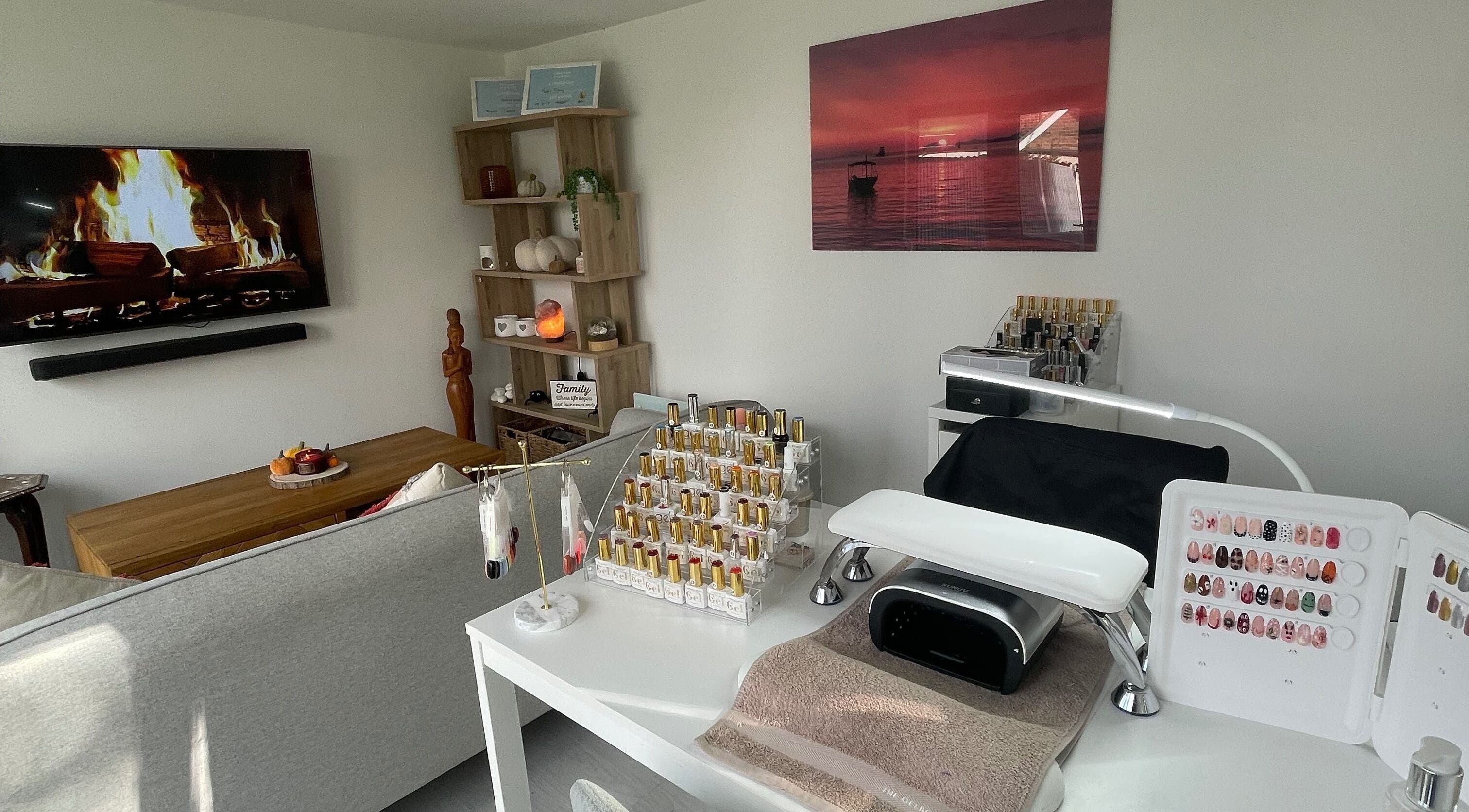 Nail station setup at Maddie's Beauty Room, Great Baddow, England, GB with cozy decor and polish display.