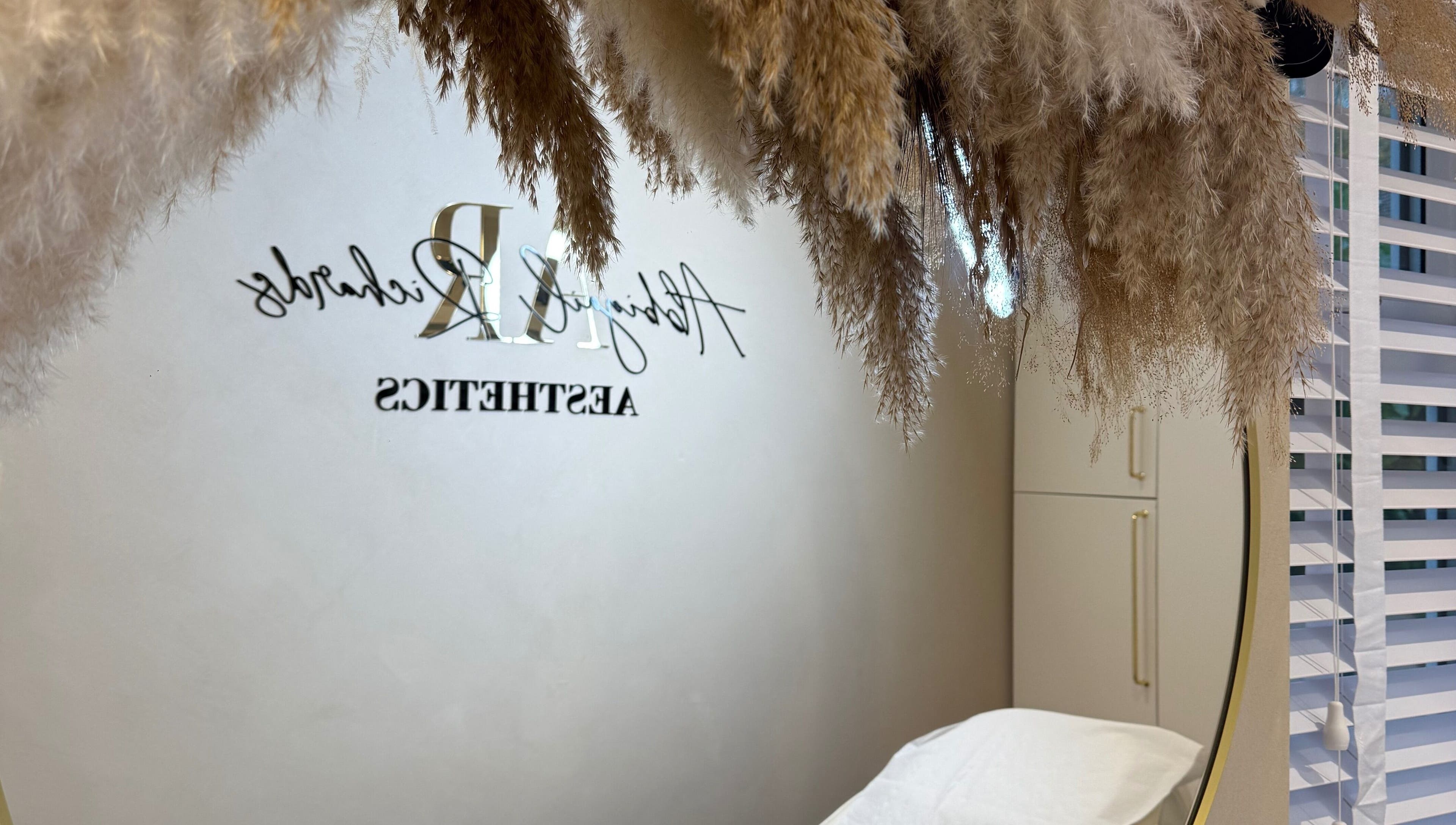 Elegant interior at Abbigail Richards Hair, Makeup & Aesthetics in Reading, England, GB with pampas grass decor.