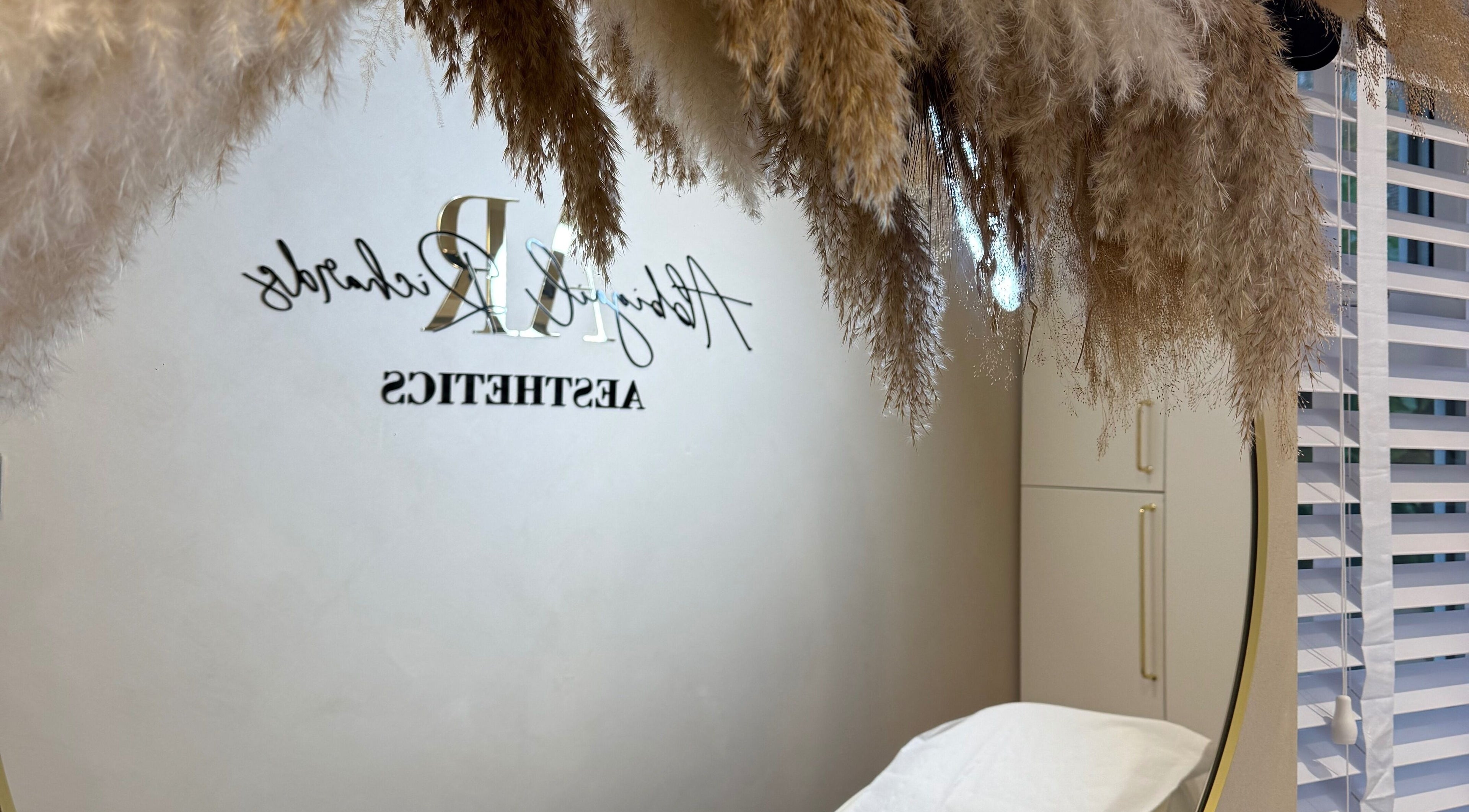 Elegant interior at Abbigail Richards Hair, Makeup & Aesthetics in Reading, England, GB with pampas grass decor.