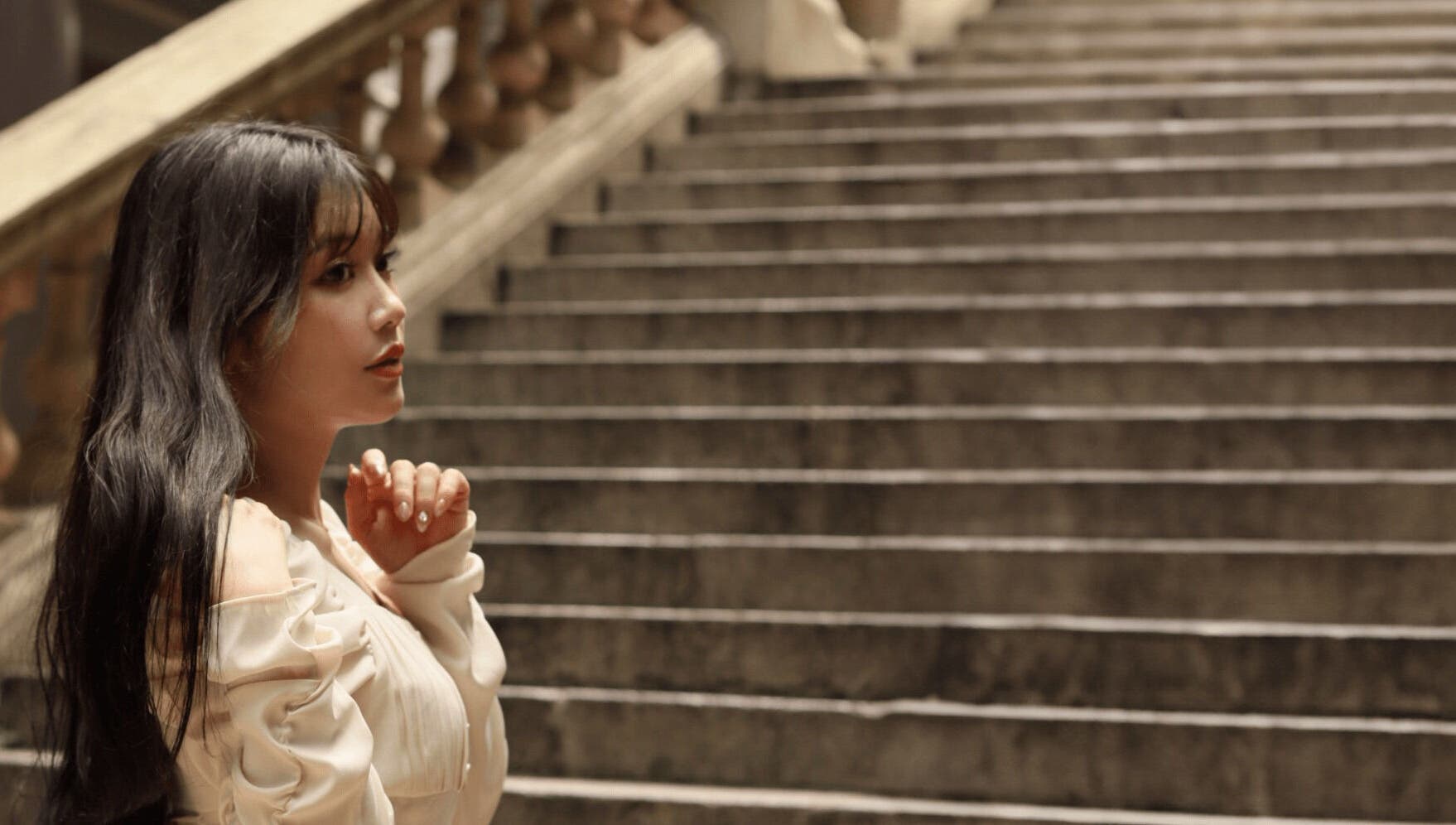 Woman in elegant attire on Carte Blanche Beta Site staircase, Hong Kong Island, HK.