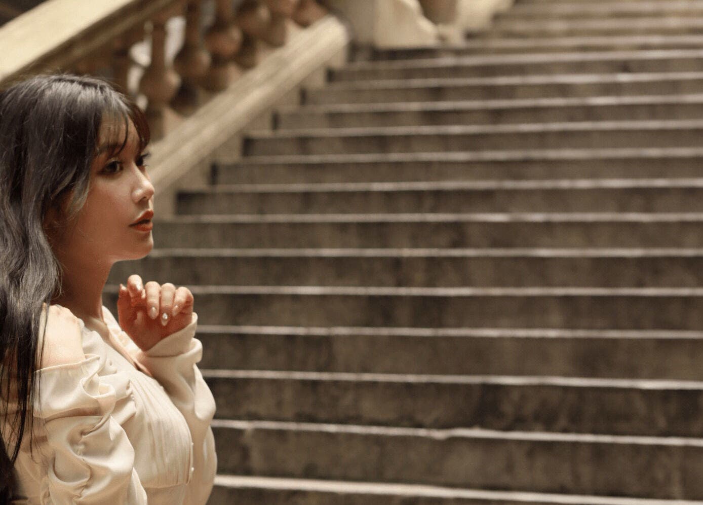 Woman in elegant attire on Carte Blanche Beta Site staircase, Hong Kong Island, HK.