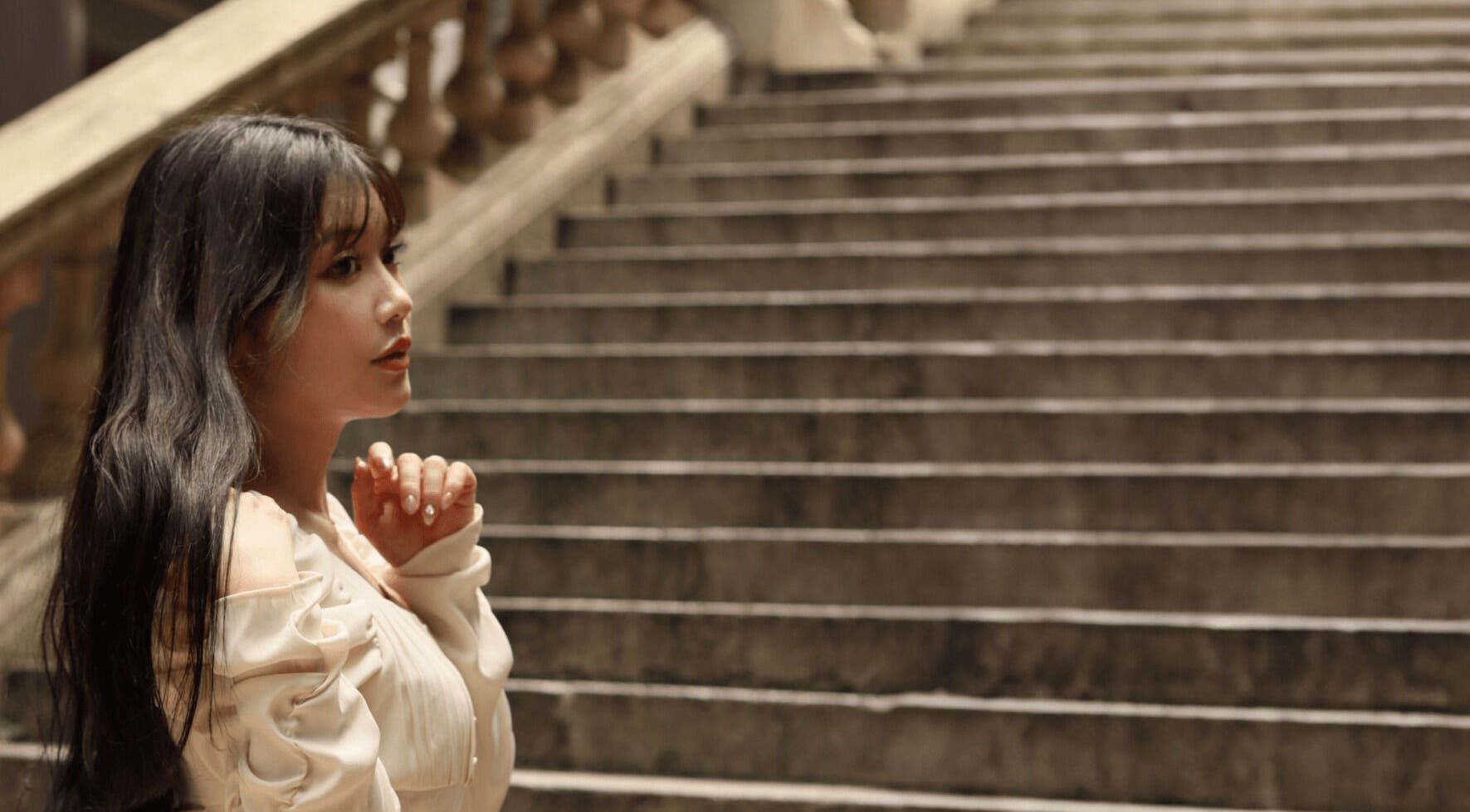 Woman in elegant attire on Carte Blanche Beta Site staircase, Hong Kong Island, HK.