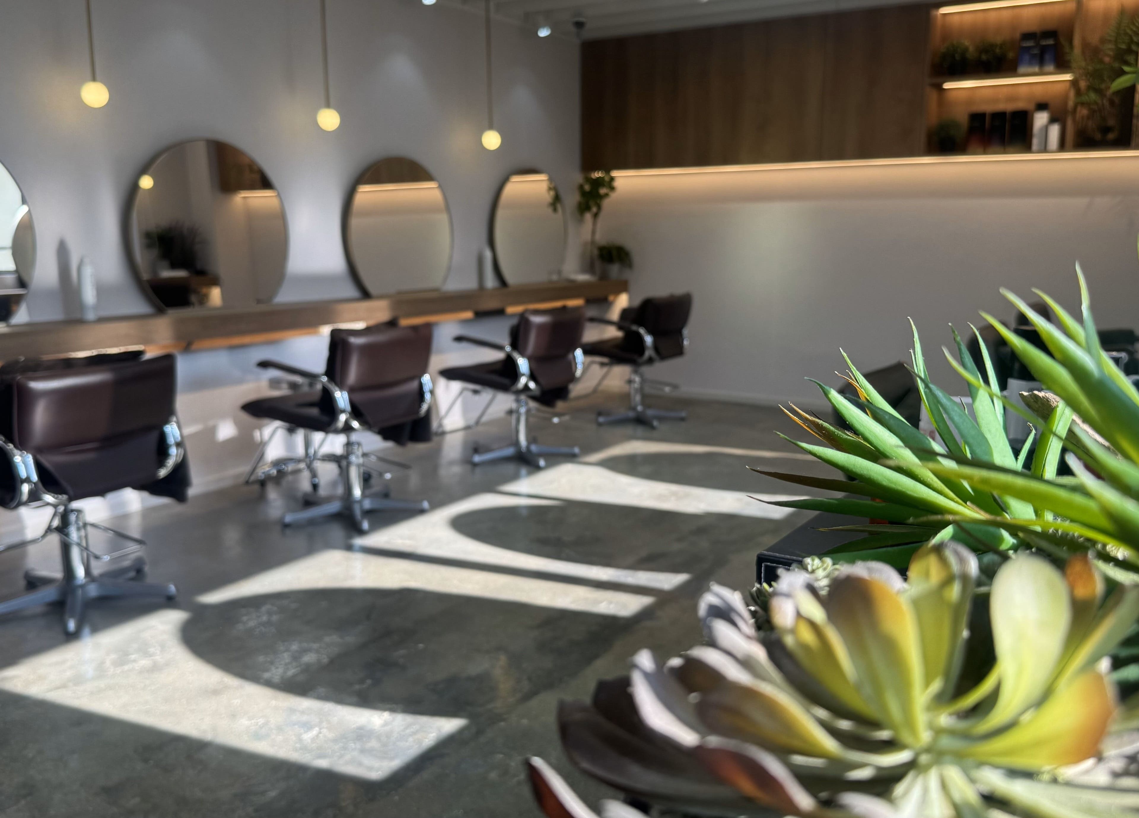 Modern salon chairs and mirrors at Carte Blanche Beta Site, Hong Kong Island, HK, with stylish lighting.