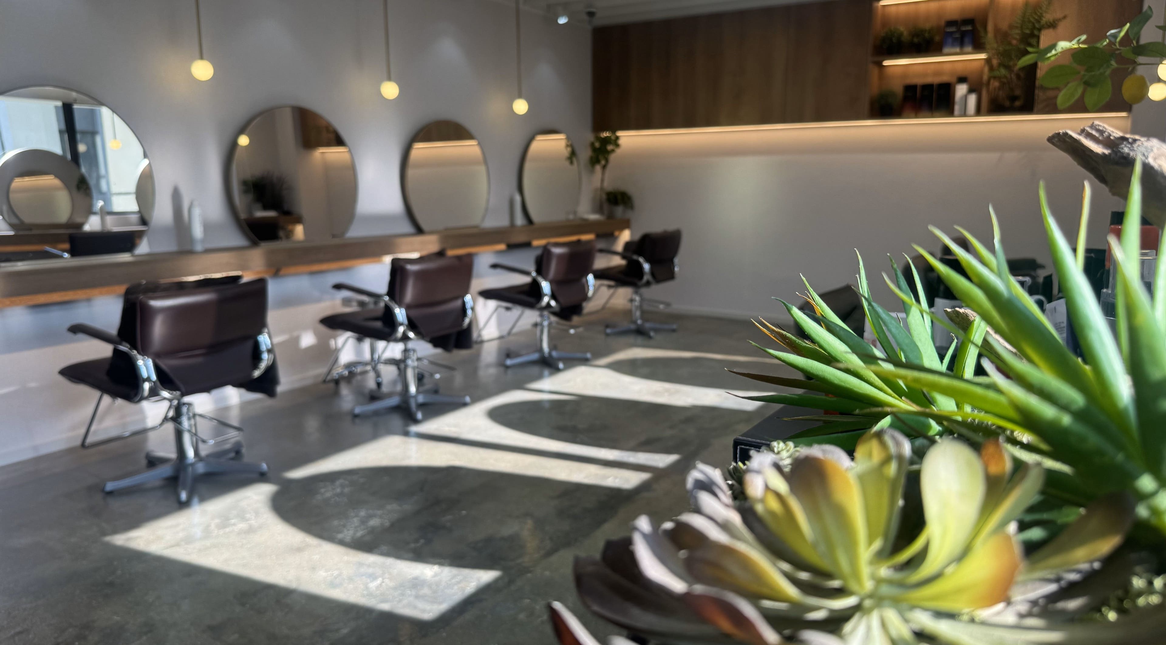 Modern salon chairs and mirrors at Carte Blanche Beta Site, Hong Kong Island, HK, with stylish lighting.