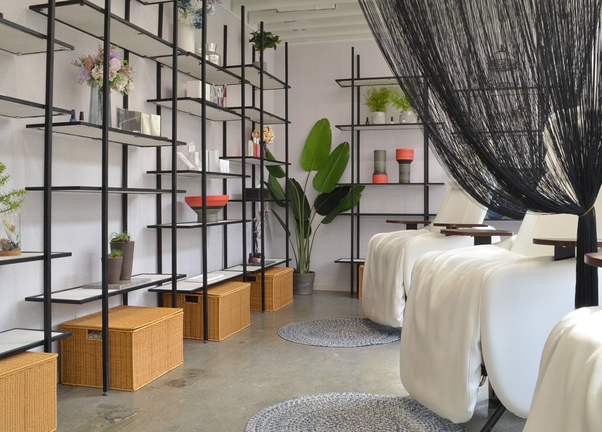 Elegant spa interior at Carte Blanche Beta Site, Hong Kong Island, HK with white recliners and decorative shelves.