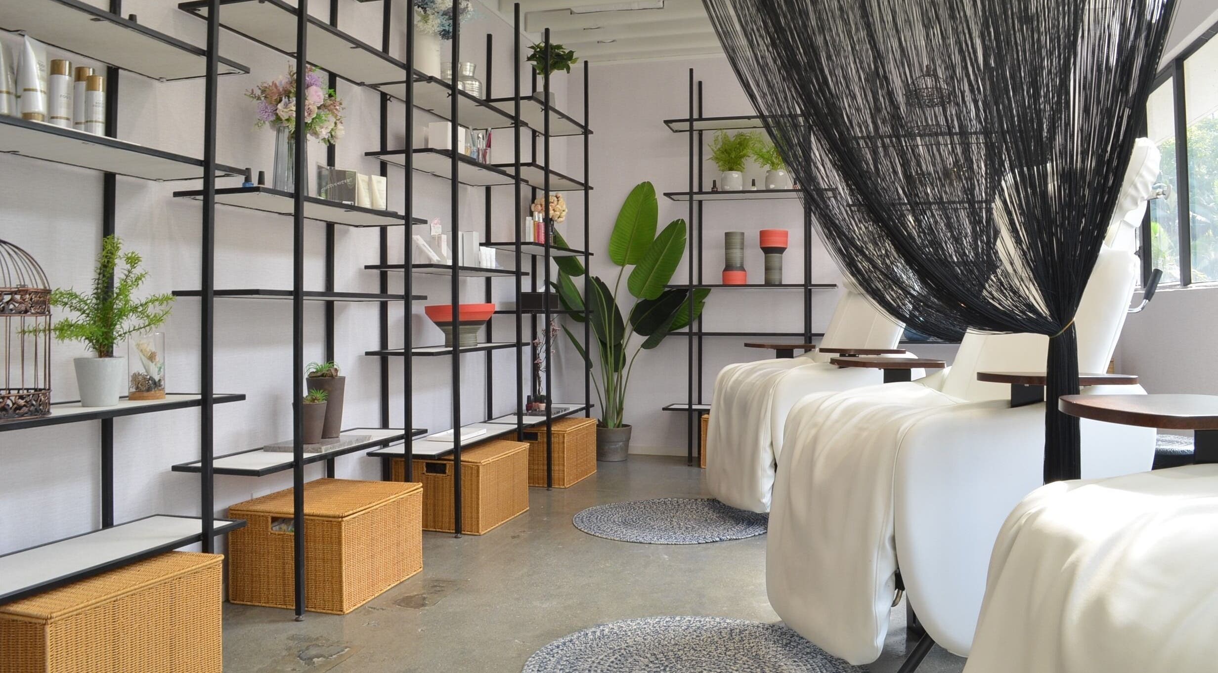 Elegant spa interior at Carte Blanche Beta Site, Hong Kong Island, HK with white recliners and decorative shelves.