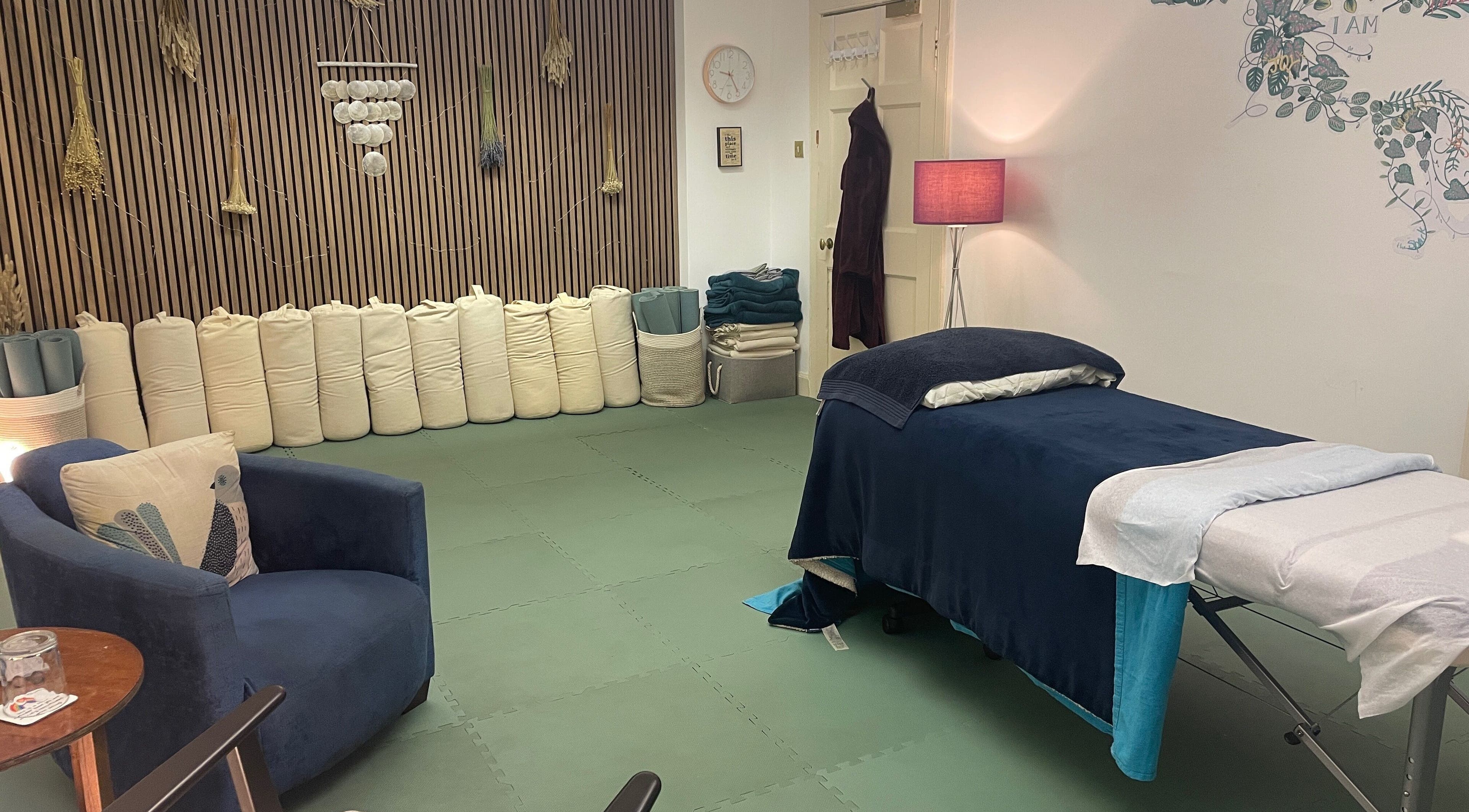 Tranquil therapy room at Calmer Being, Edinburgh, Scotland, GB with a cozy massage table and calming decor.