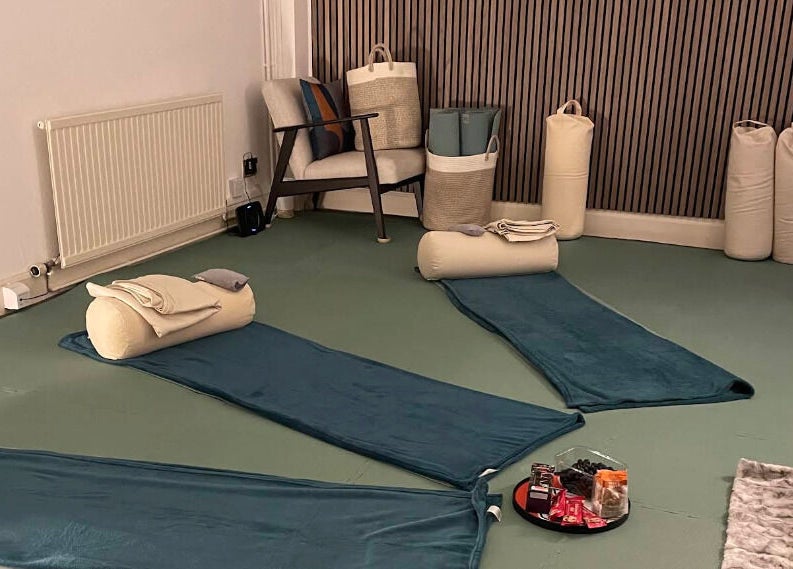 Yoga mats and cushions in a serene room at Calmer Being, Edinburgh, Scotland, GB, designed for relaxation.