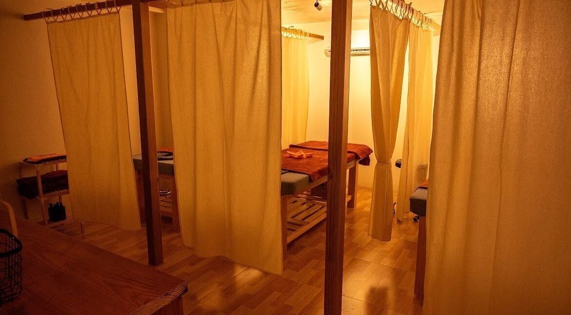 Private treatment room at The Spa Saigon, Thành Phố Hồ Chí Minh, VN with warm lighting and wooden decor.