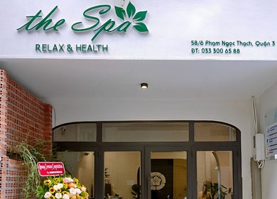 Entrance of The Spa Saigon in Thành Phố Hồ Chí Minh, VN showcasing modern facade with floral decor.