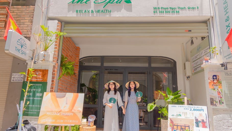 Front view of The Spa&Aodai in Hồ Chí Minh, VN with welcoming staff in traditional attire.