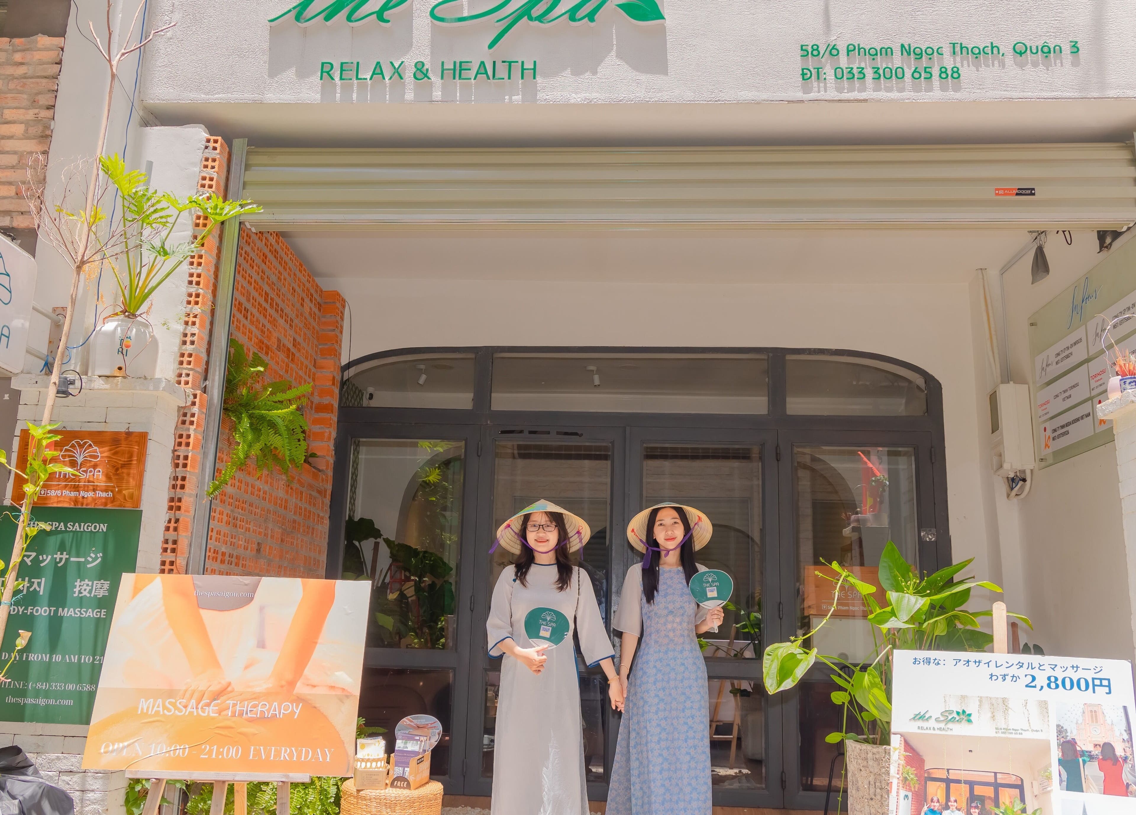 Front view of The Spa&Aodai in Hồ Chí Minh, VN with welcoming staff in traditional attire.