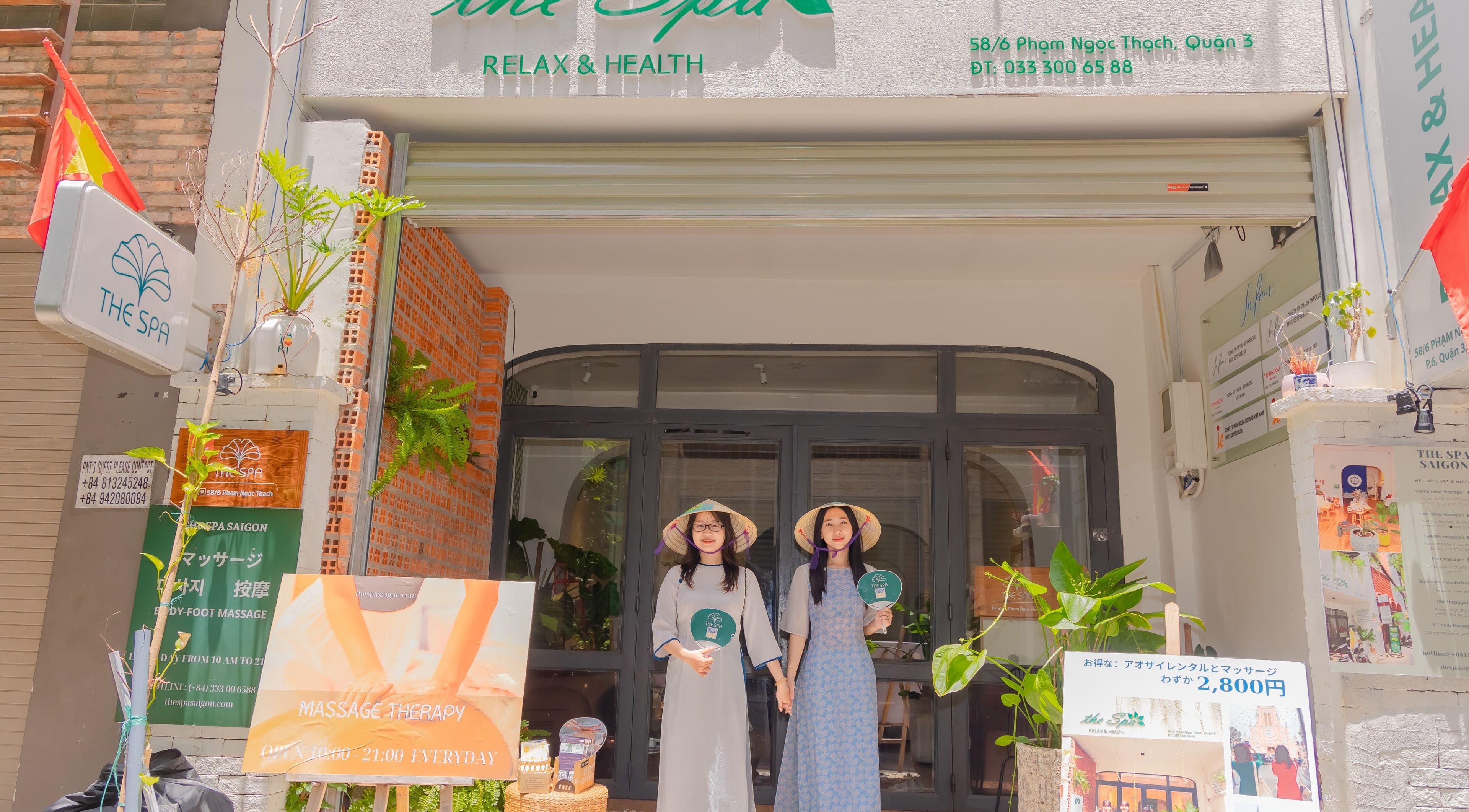 Front view of The Spa&Aodai in Hồ Chí Minh, VN with welcoming staff in traditional attire.