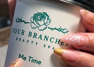 Elegant nail art holding a Four Branches Spa Beauty cup in Riyadh, Riyadh Province, SA.