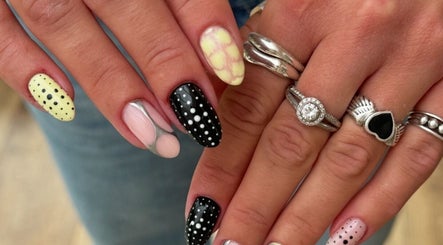 Artistic nail designs at Freshsetcait in Colchester, England, GB featuring polka dots and intricate patterns.
